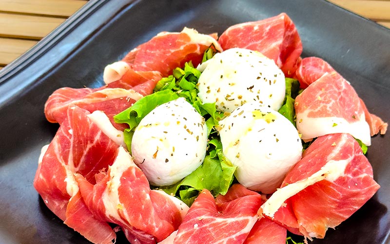 PalmBeach Tropical Restaurant | Parma Ham and Buffalo Mozzarella | 8-month aged parma cured ham, buffalo mozzarella, oregano, and lettuce